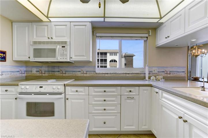 Corian counters, plenty of white raised panel cabinetry, extra window in the kitchen!