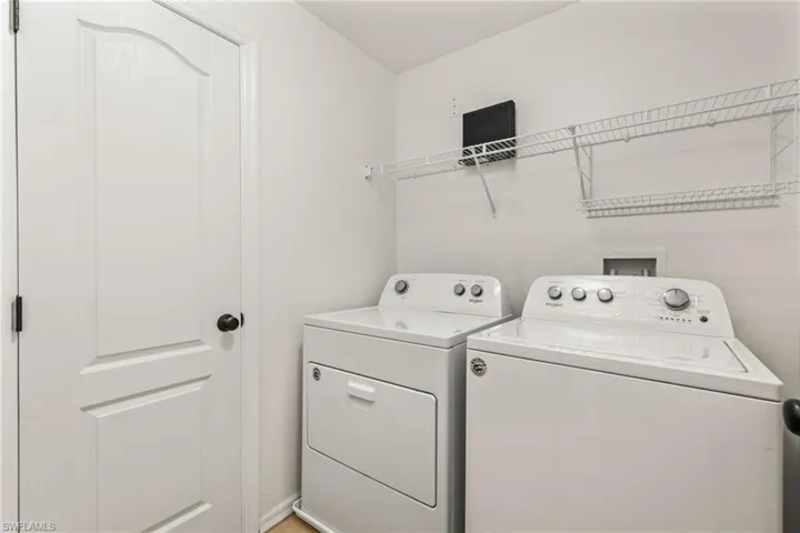 Clothes washing area featuring washing machine and clothes dryer and washer hookup