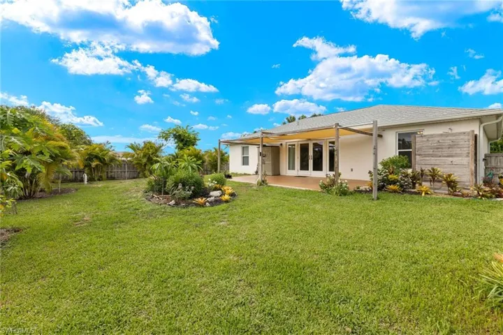Rear view of property featuring a patio area and a yard