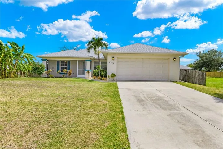 Ranch-style home featuring a garage and a front yard