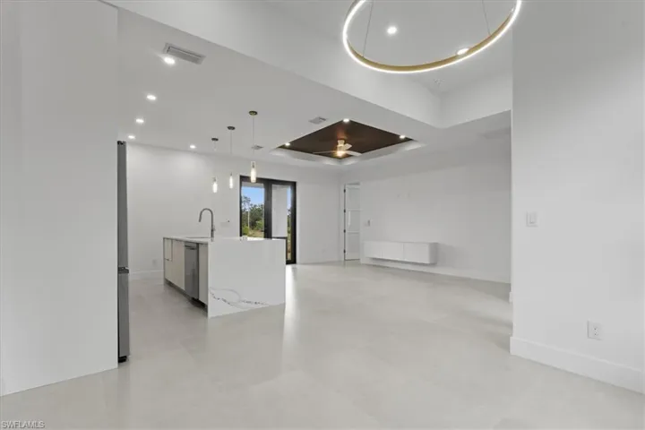 Unfurnished room featuring a raised ceiling and recessed lighting