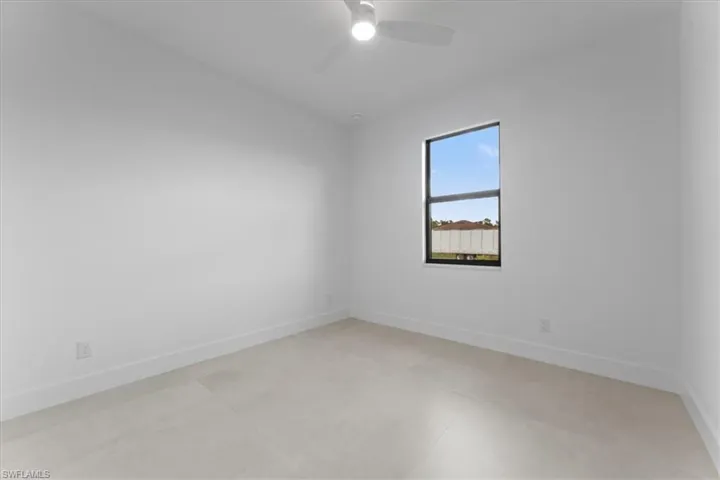 Spare room featuring baseboards and ceiling fan