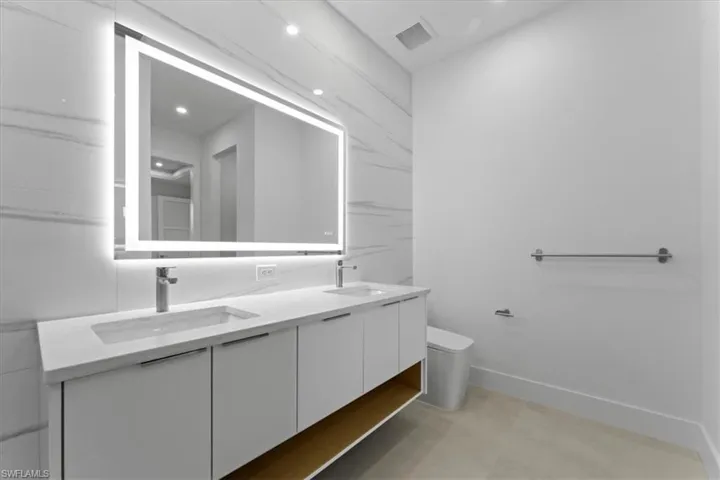 Full bath with double vanity and recessed lighting