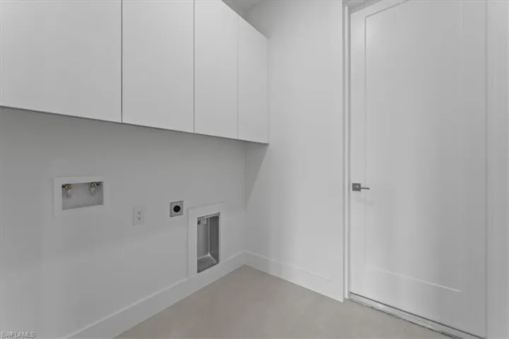 Laundry area with electric dryer hookup, washer hookup, and cabinet space