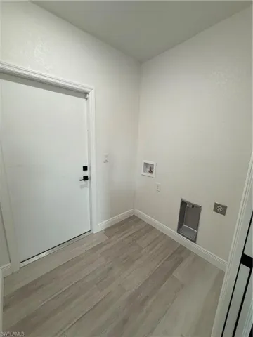 Laundry area featuring light wood-style floors, washer hookup, and electric dryer hookup