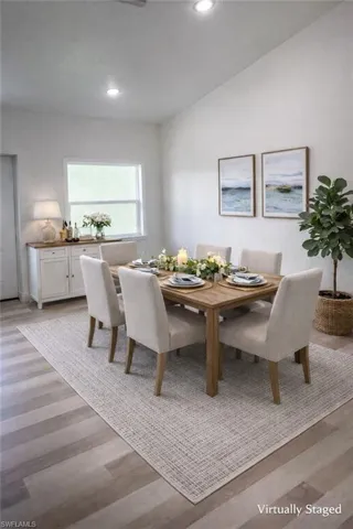 Dining area with light wood-type flooring and recessed lighting