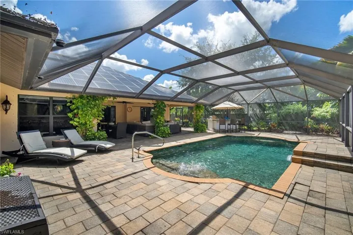 View of pool with a patio and a lanai