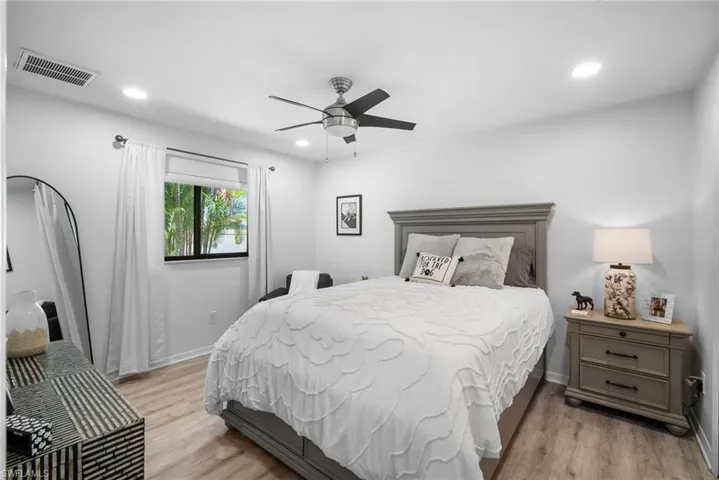 Bedroom with ceiling fan and light hardwood / wood-style flooring