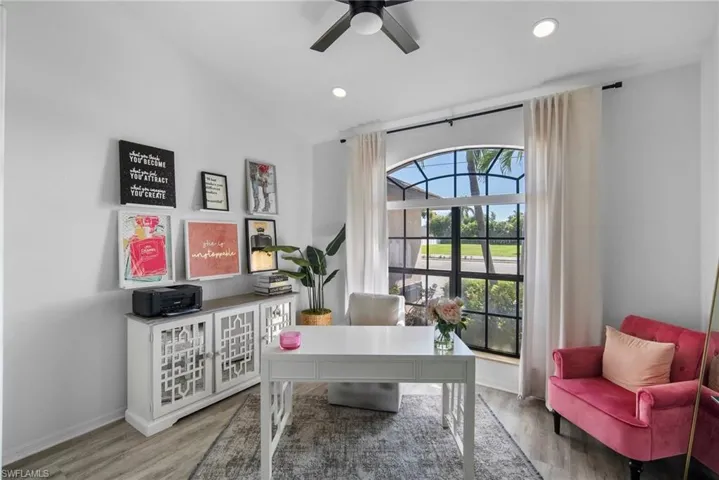 Office space featuring light hardwood / wood-style floors, lofted ceiling, and ceiling fan