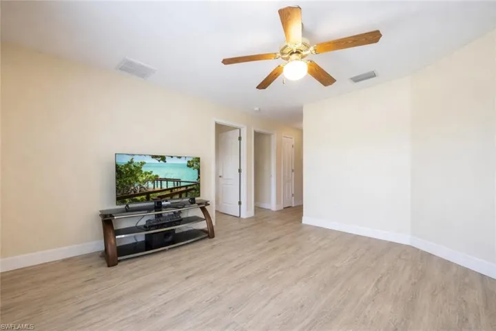 Living area with ceiling fan and light wood-type flooring