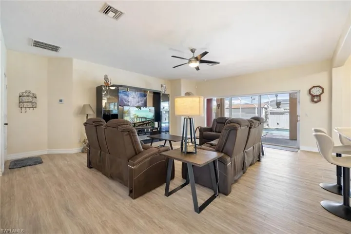 Living area featuring a ceiling fan and light wood-style flooring