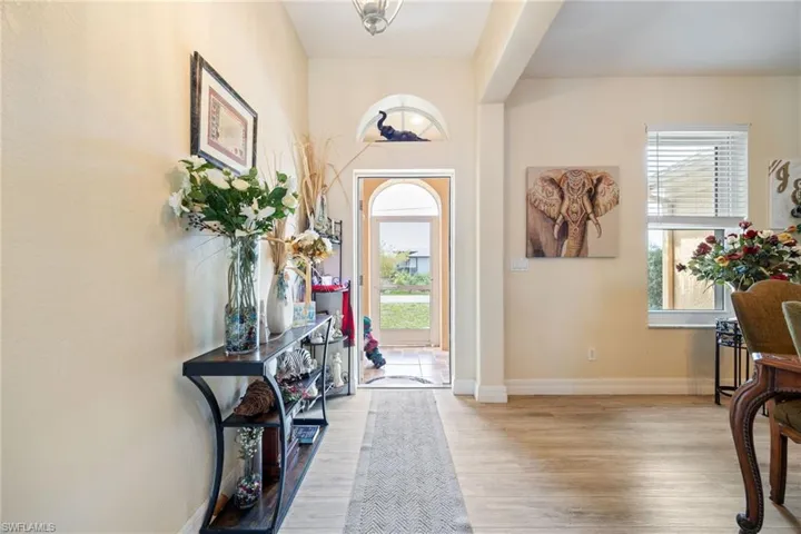 Foyer featuring light wood finished floors and baseboards