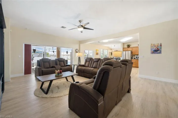 Living area with a ceiling fan and light wood-type flooring