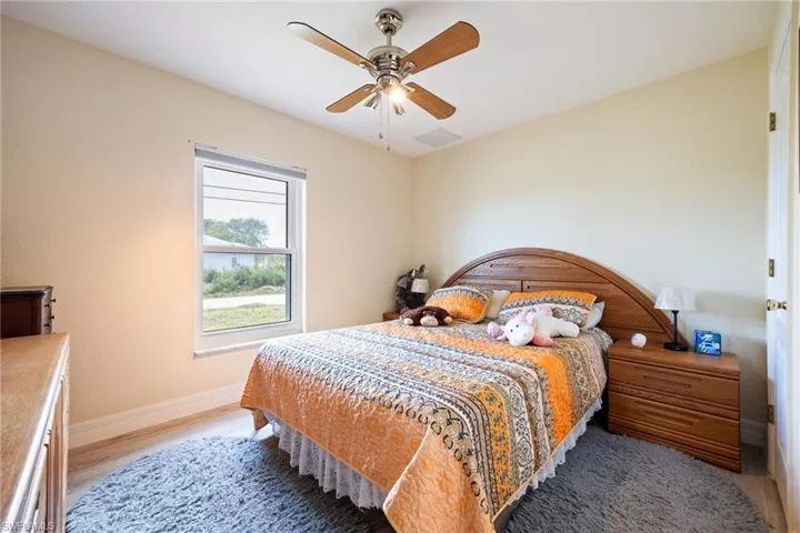 Bedroom featuring ceiling fan and light wood-type flooring