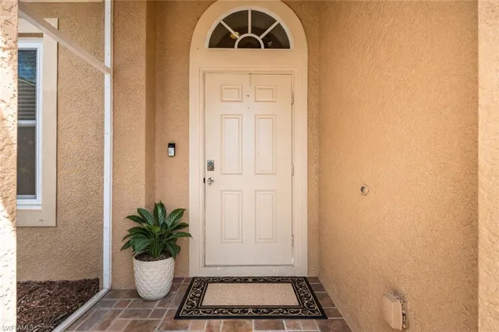 Property entrance featuring stucco siding