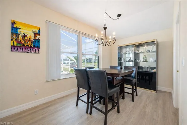 Dining space with light wood-type flooring and suspended lighting