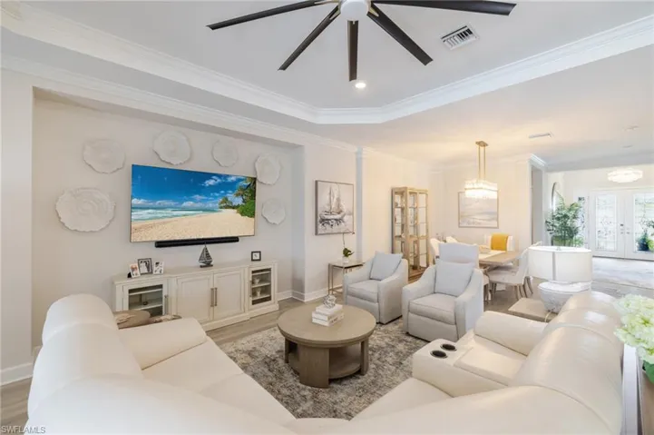 Living area featuring a ceiling fan, light wood finished floors, recessed lighting, ornamental molding, and french doors