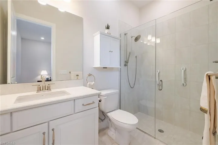 Bathroom featuring vanity and a shower stall