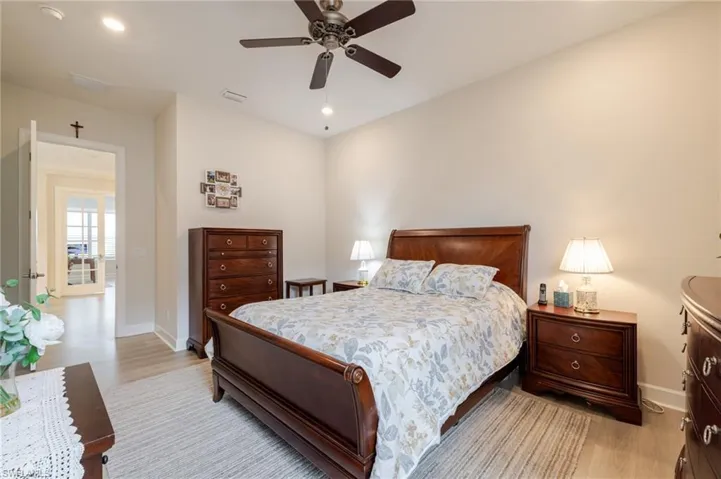 Bedroom with light wood-style flooring, a ceiling fan, and recessed lighting