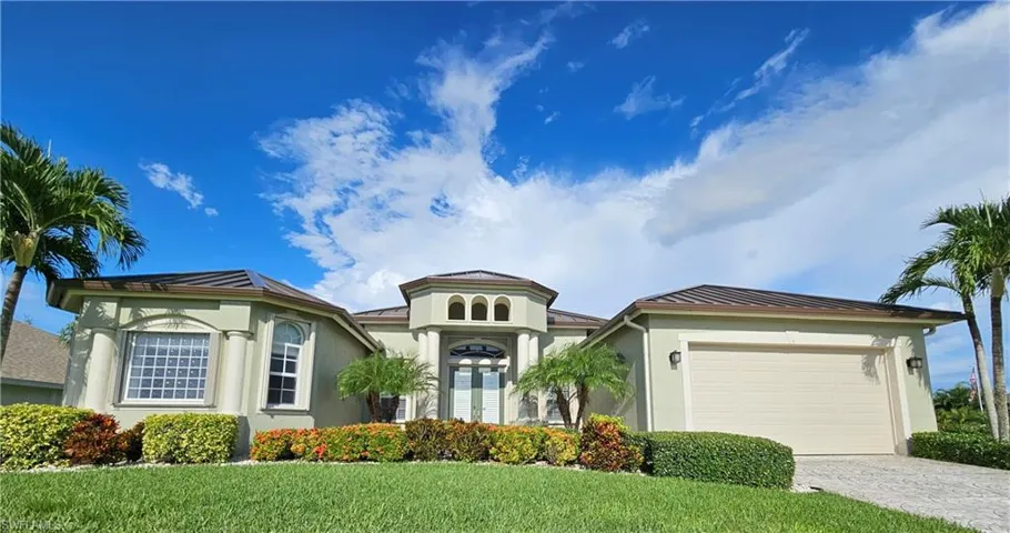 View of front of home featuring a garage and a front yard