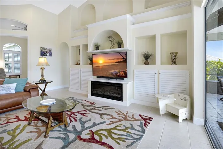 Living room, built in shelves, and a high ceiling