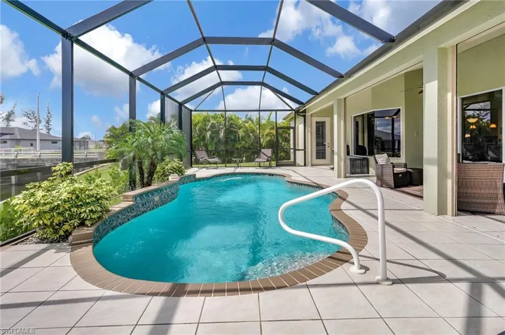 View of swimming pool with a lanai and a patio area