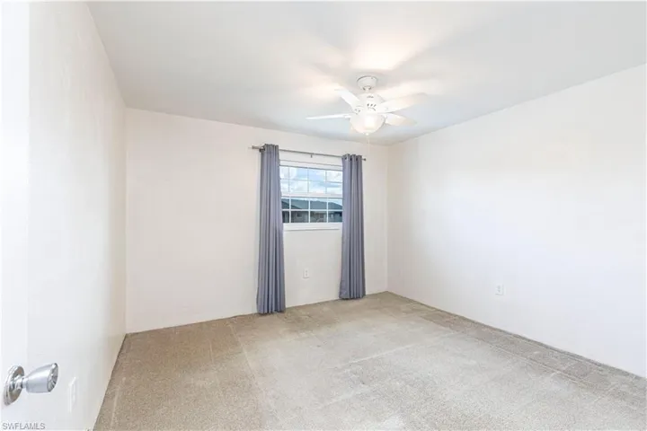 Unfurnished room with carpet and ceiling fan