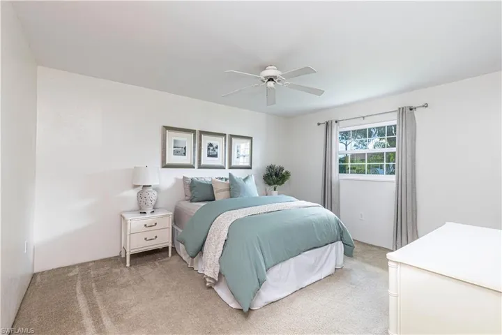 Bedroom with light carpet and ceiling fan