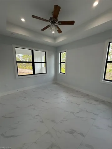 Unfurnished room with a tray ceiling