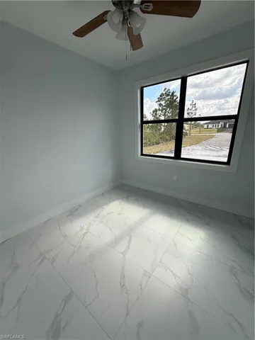 Unfurnished room featuring ceiling fan