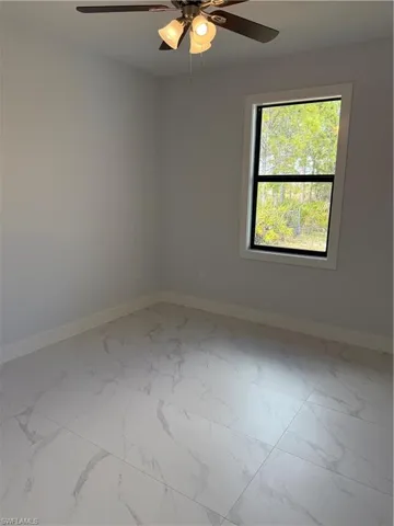 Empty room featuring ceiling fan