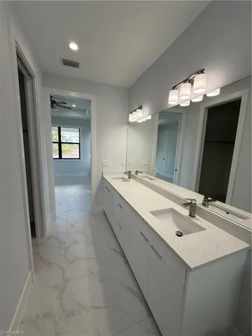 Bathroom with vanity and ceiling fan