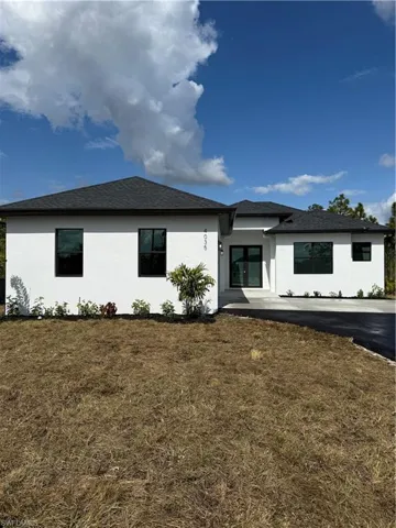 Back of house featuring a lawn