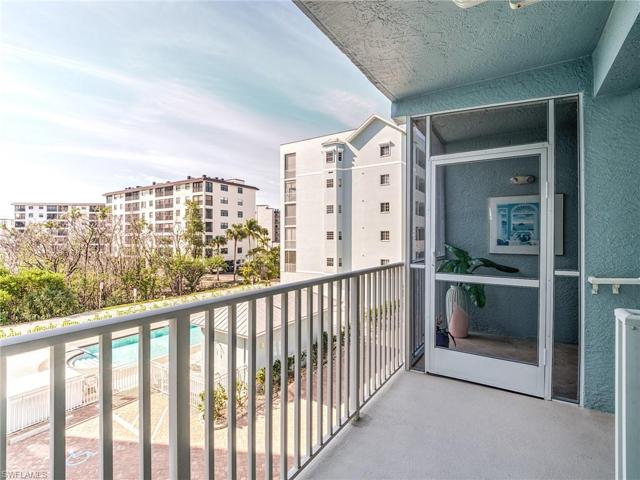 Walkway overlooking pool upon entering private and covered screened lanai entryway.