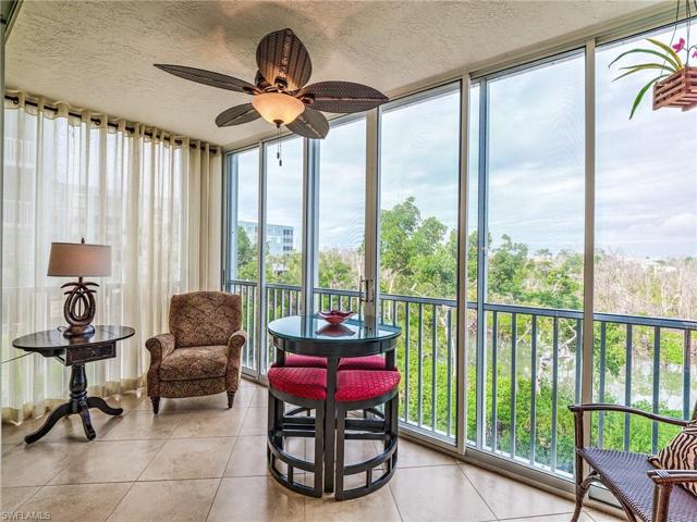 Serene setting with waterfront views from floor to ceiling glass enclosed screened lanai overlooking nature preserve and bird sanctuary, home to beach birds such as egrets, herons and roseate spoonbills amongst SWFL's protected mangroves.