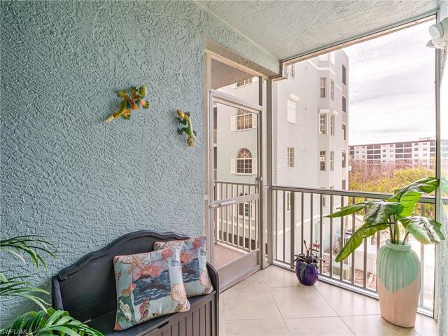 Private and covered screened lanai entryway with sitting area.