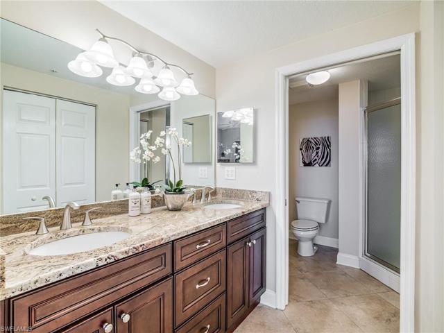 Rich comfort height cabinetry with granite dual sink top.