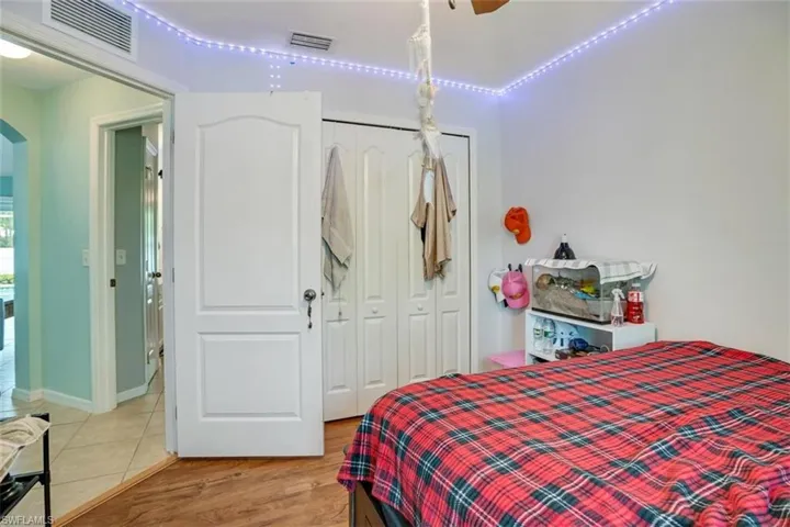 Bedroom featuring wood-type flooring, a closet, and ceiling fan