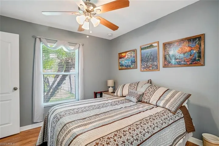Bedroom with ceiling fan and light hardwood / wood-style floors