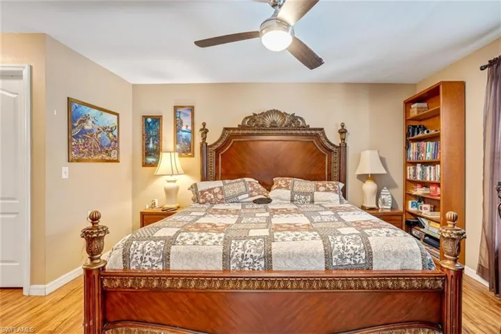 Bedroom with ceiling fan and light hardwood / wood-style flooring