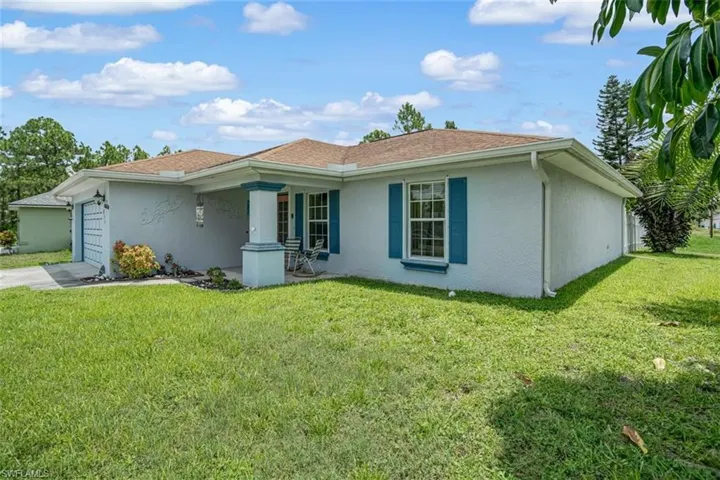 Single story home with a front lawn and a garage