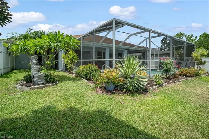 View of yard with glass enclosure
