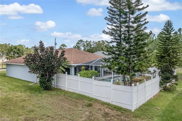 Back of property with a yard