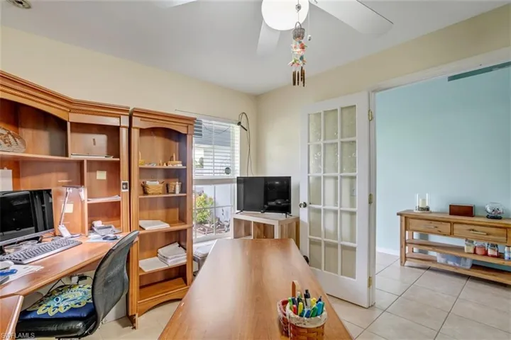 Tiled office featuring ceiling fan