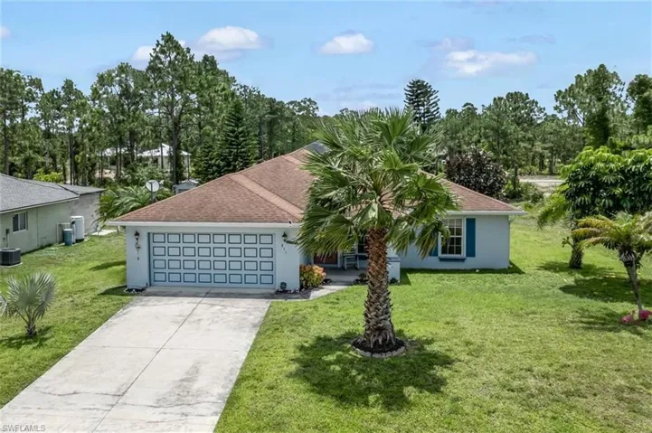 Ranch-style house with central AC, a front lawn, and a garage