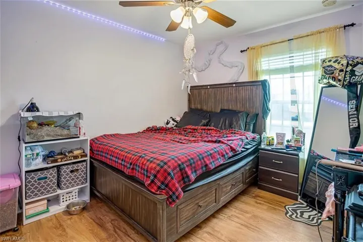 Bedroom featuring ceiling fan and light wood-type flooring