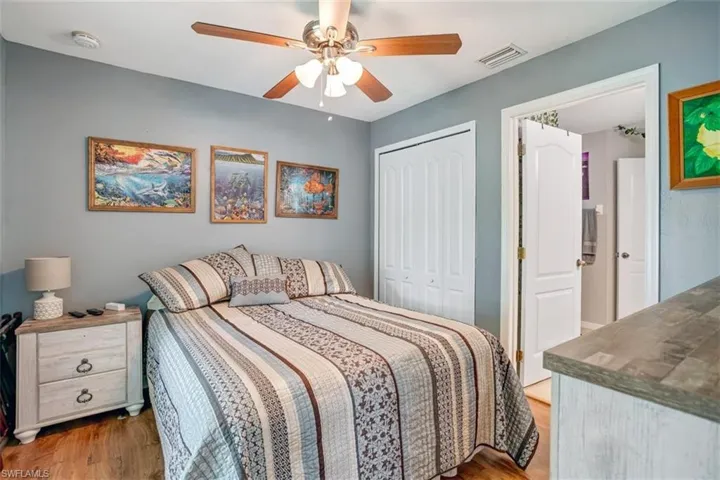 Bedroom featuring ceiling fan, a closet, and hardwood / wood-style flooring
