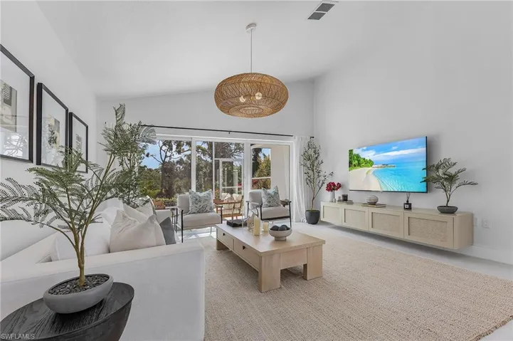 Living room featuring high vaulted ceiling