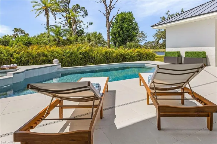 View of swimming pool featuring a jacuzzi and a patio