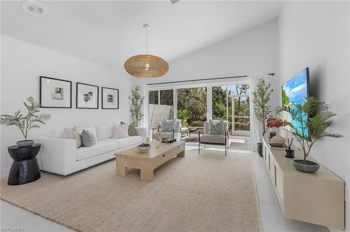 Tiled living room with high vaulted ceiling